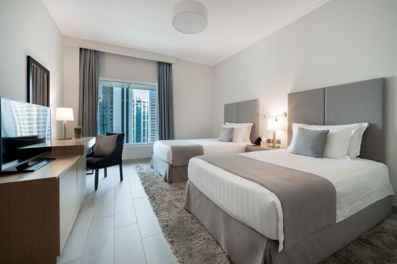 Centara West Bay Hotel & Residences Doha Bagian luar foto A typical guest room at the hotel